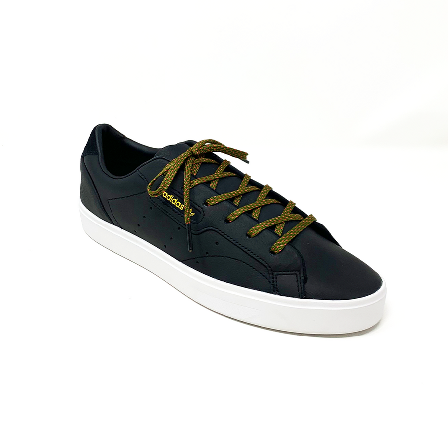 Olive Green & Guava ticked flat shoelaces laced into a black low-top sneaker