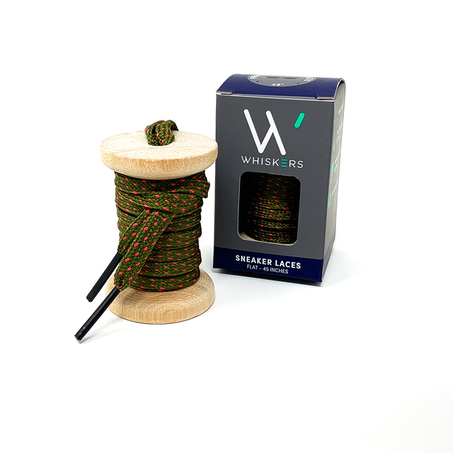 Olive Green & Guava ticked flat shoelaces on a wooden spool beside the retail box