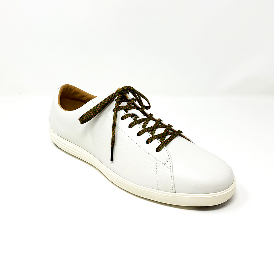 Olive Green & Guava ticked flat shoelaces laced into a cream low-top sneaker