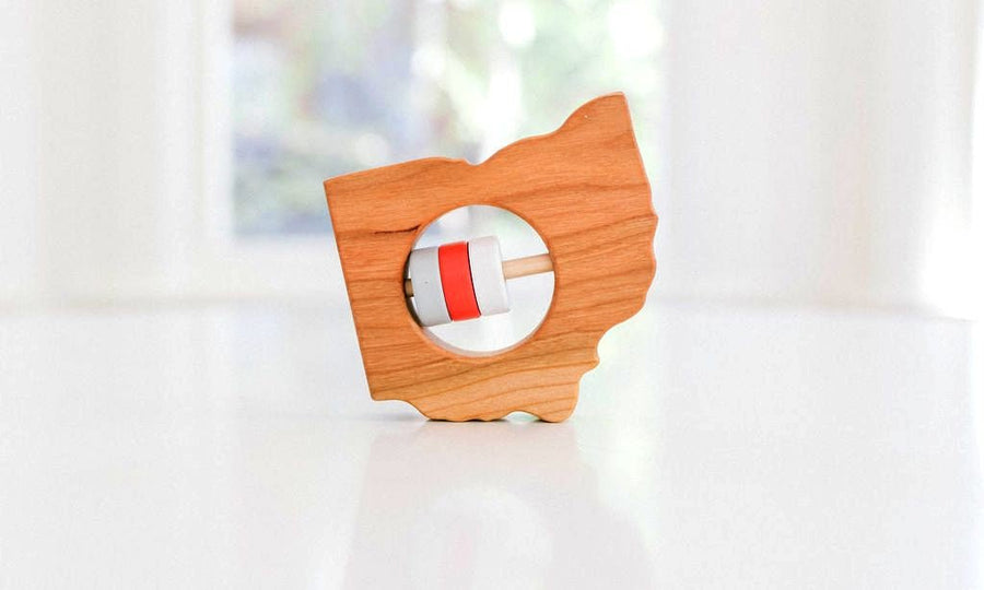 Ohio state-shaped cherry wood baby rattle with colored center disks