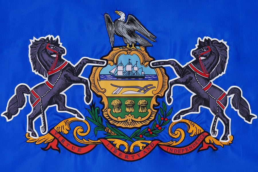 Pennsylvania state flag close-up with horses eagle shield and motto