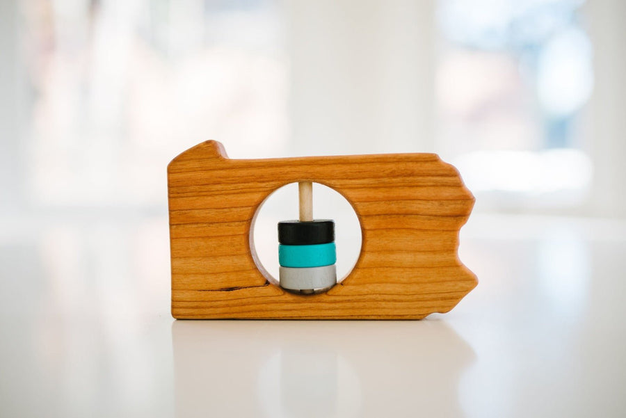 Pennsylvania state-shaped cherry wood baby rattle with colored center disks
