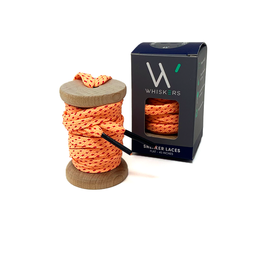 Peach & Fuchsia ticked flat shoelaces on a wooden spool beside the retail box