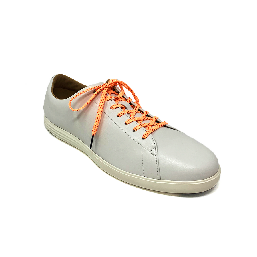 Peach & Fuchsia ticked flat shoelaces laced into a cream low-top sneaker