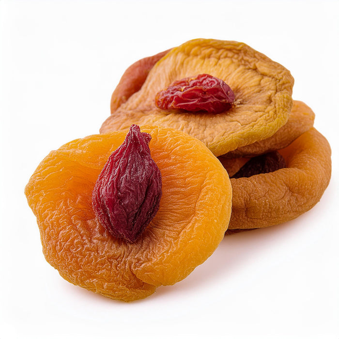 Dried peach halves on a plain white background.