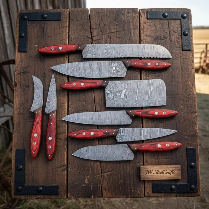 Eight-piece Damascus kitchen knife set with red Pakka wood handles and leather roll