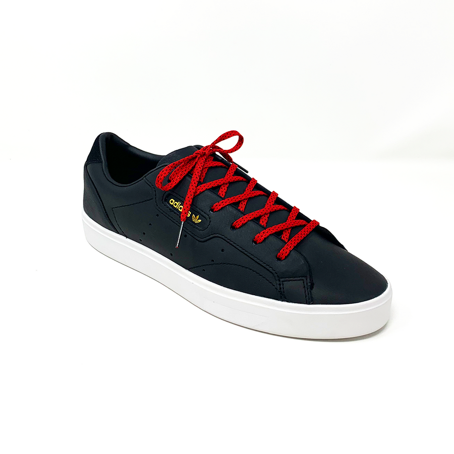 Red & Black ticked flat shoelaces laced into a black low-top sneaker