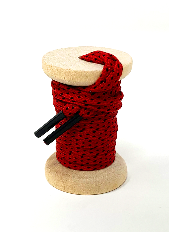 Red & Black ticked flat shoelaces on a wooden spool