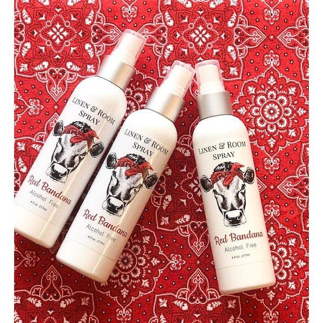 Red Bandana room and linen spray bottles displayed on red bandana fabric