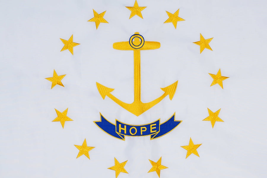 Rhode Island state flag close-up with anchor thirteen stars and Hope ribbon