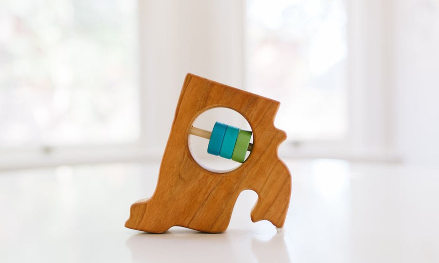 Rhode Island state-shaped cherry wood baby rattle with colored center disks