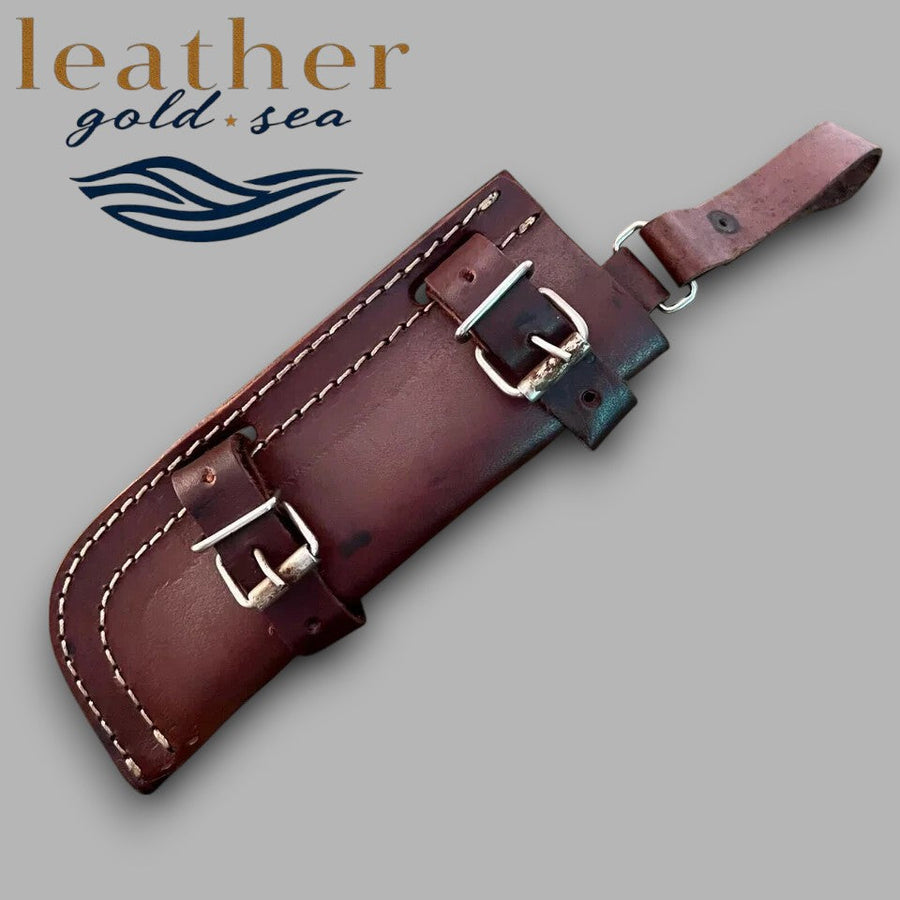 Dark brown leather knife sheath showing buckle straps