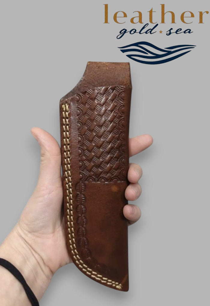 Hand holding brown basketweave-pattern knife sheath
