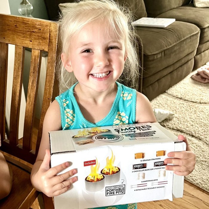 Child holding a boxed s’mores Family Pack