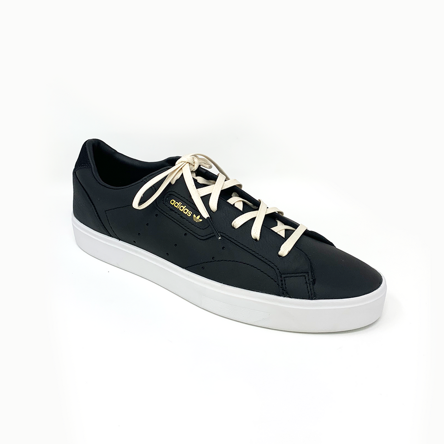 Cream glazed cotton shoelaces laced into a black low-top sneaker
