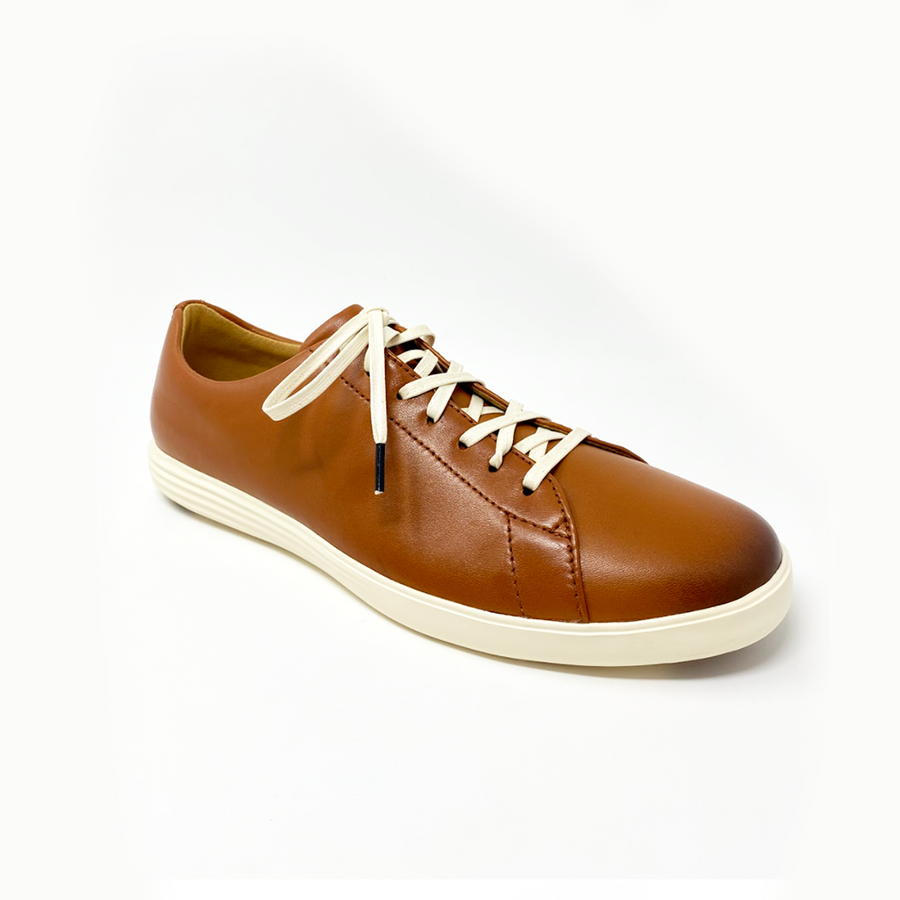 Cream glazed cotton shoelaces laced into a brown leather sneaker