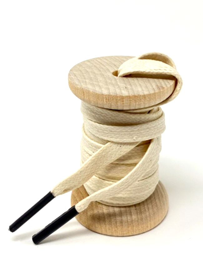 Cream glazed cotton shoelaces on a wooden spool
