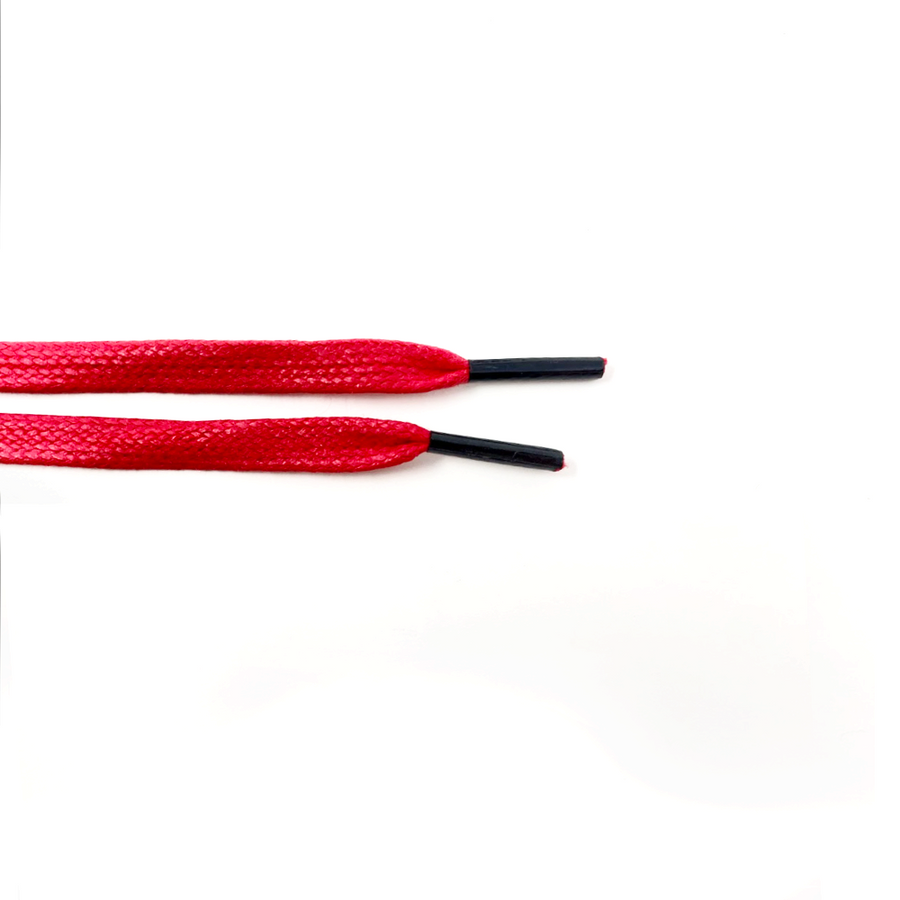 Red glazed cotton shoelaces close-up of flat cotton lace ends and black aglets