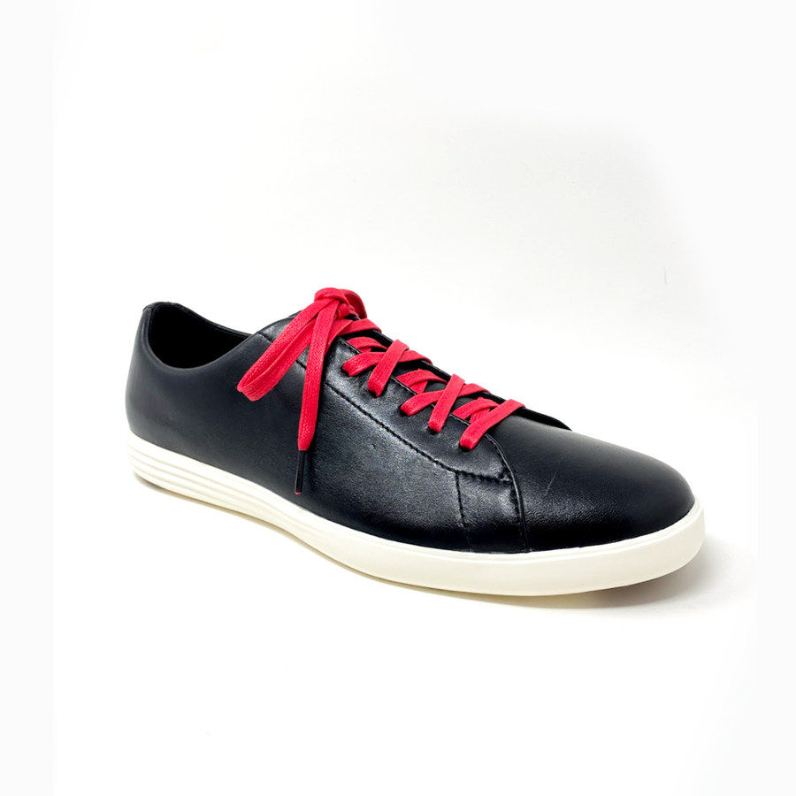 Red glazed cotton shoelaces laced into a black leather sneaker