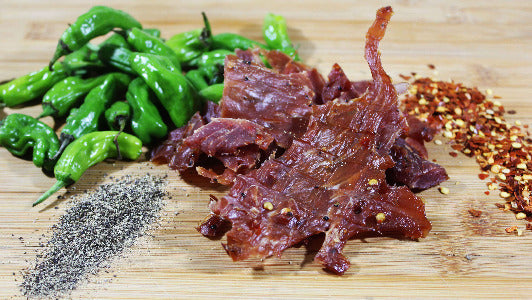 Spicy pork jerky with green peppers and cracked pepper seasoning