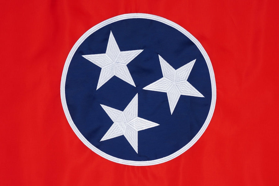 Tennessee state flag close-up with three white stars in blue circle