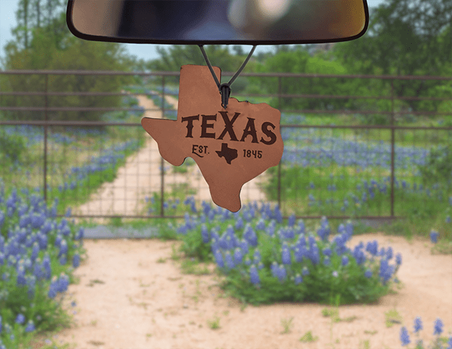 Texas-shaped leather car air freshener with Texas lettering and an 1845 detail