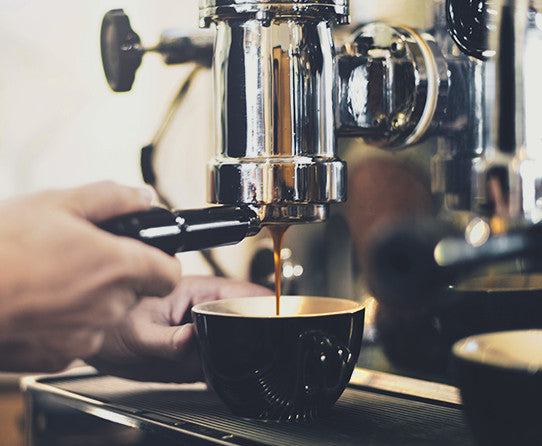 Espresso machine pouring coffee into a cup