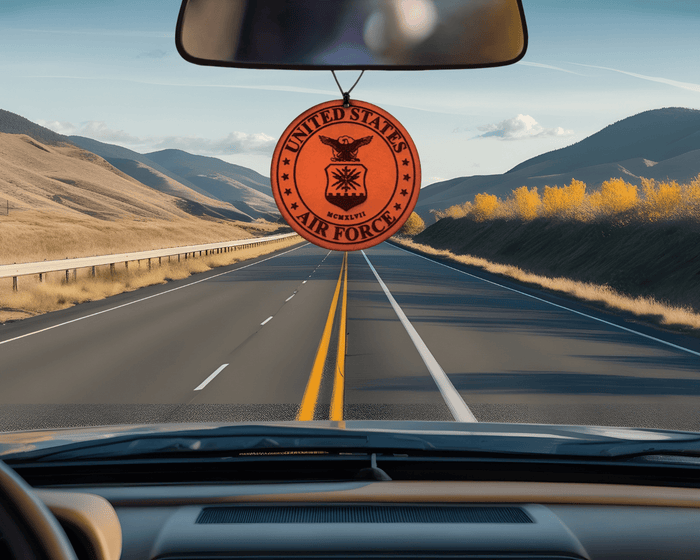 Round Air Force emblem leather car air freshener pictured below a vehicle rearview mirror