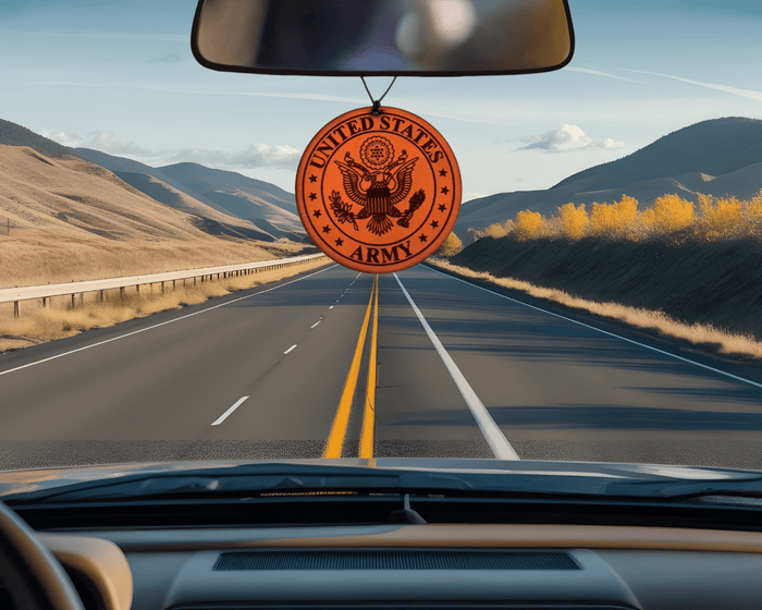 Round Army emblem leather car air freshener pictured below a vehicle rearview mirror