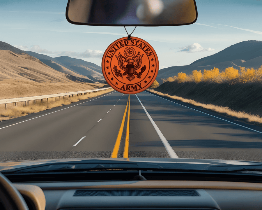 Round Army emblem leather car air freshener pictured below a vehicle rearview mirror