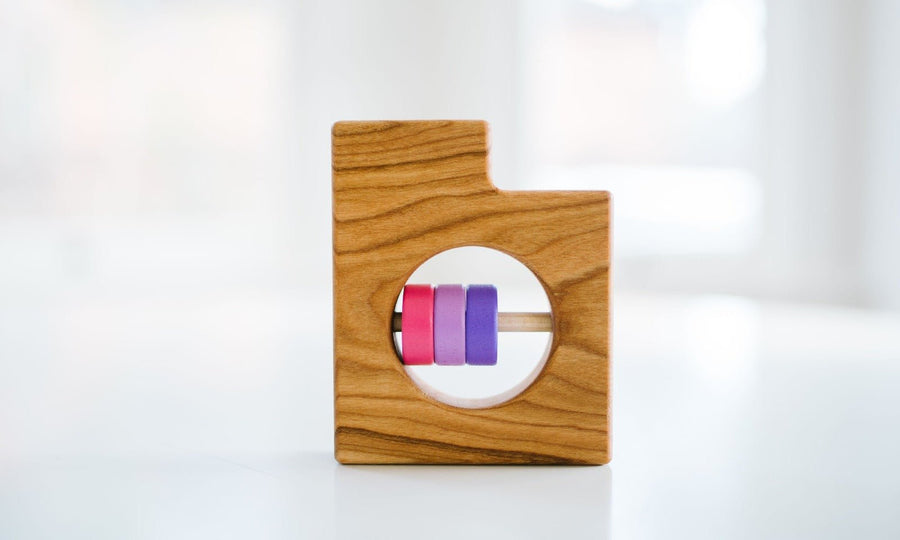 Utah state-shaped cherry wood baby rattle with colored center disks