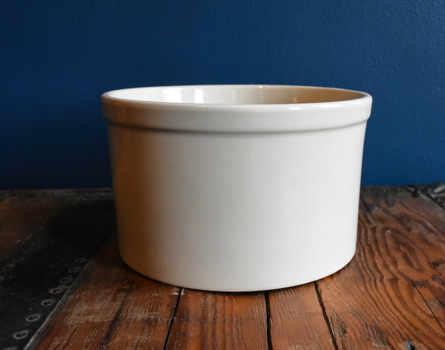 Bristol off-white stoneware utility crock - 1 quart low profile on a wood surface