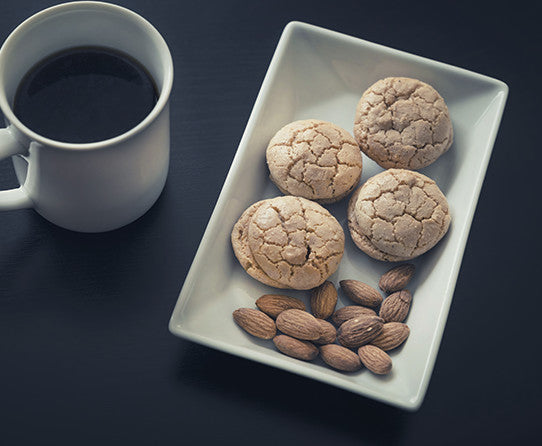 Coffee and almond cookies pictured as flavor inspiration for Vanilla Almond coffee
