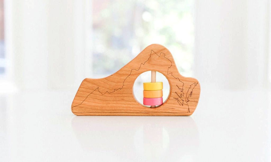 Virginia state-shaped cherry wood baby rattle with colored center disks