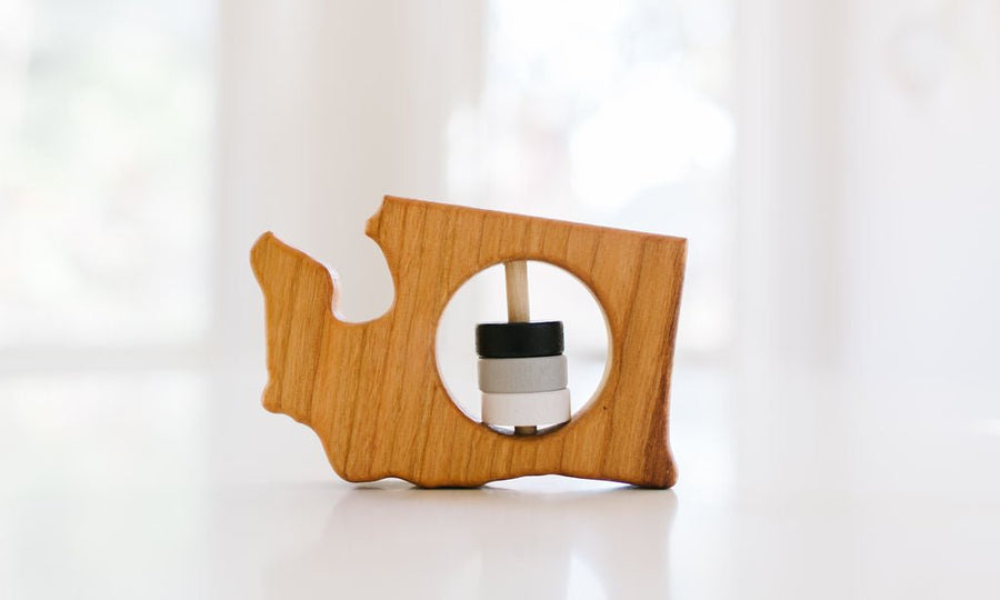 Washington state-shaped cherry wood baby rattle with colored center disks