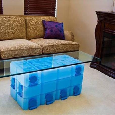 WaterBrick containers arranged as a low table beside a sofa
