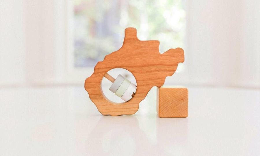 West Virginia state-shaped cherry wood baby rattle with colored center disks