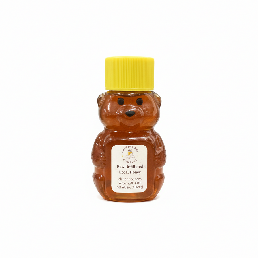 Small raw wildflower honey bear bottle on white