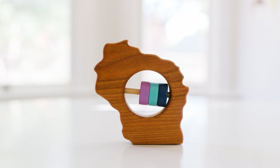 Wisconsin state-shaped cherry wood baby rattle with colored center disks