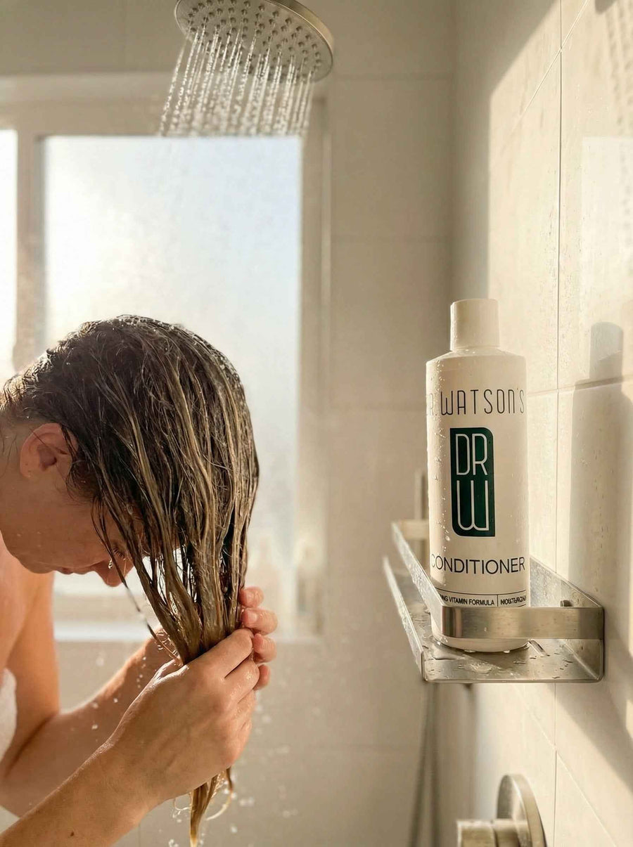 Person working conditioner through long wet hair