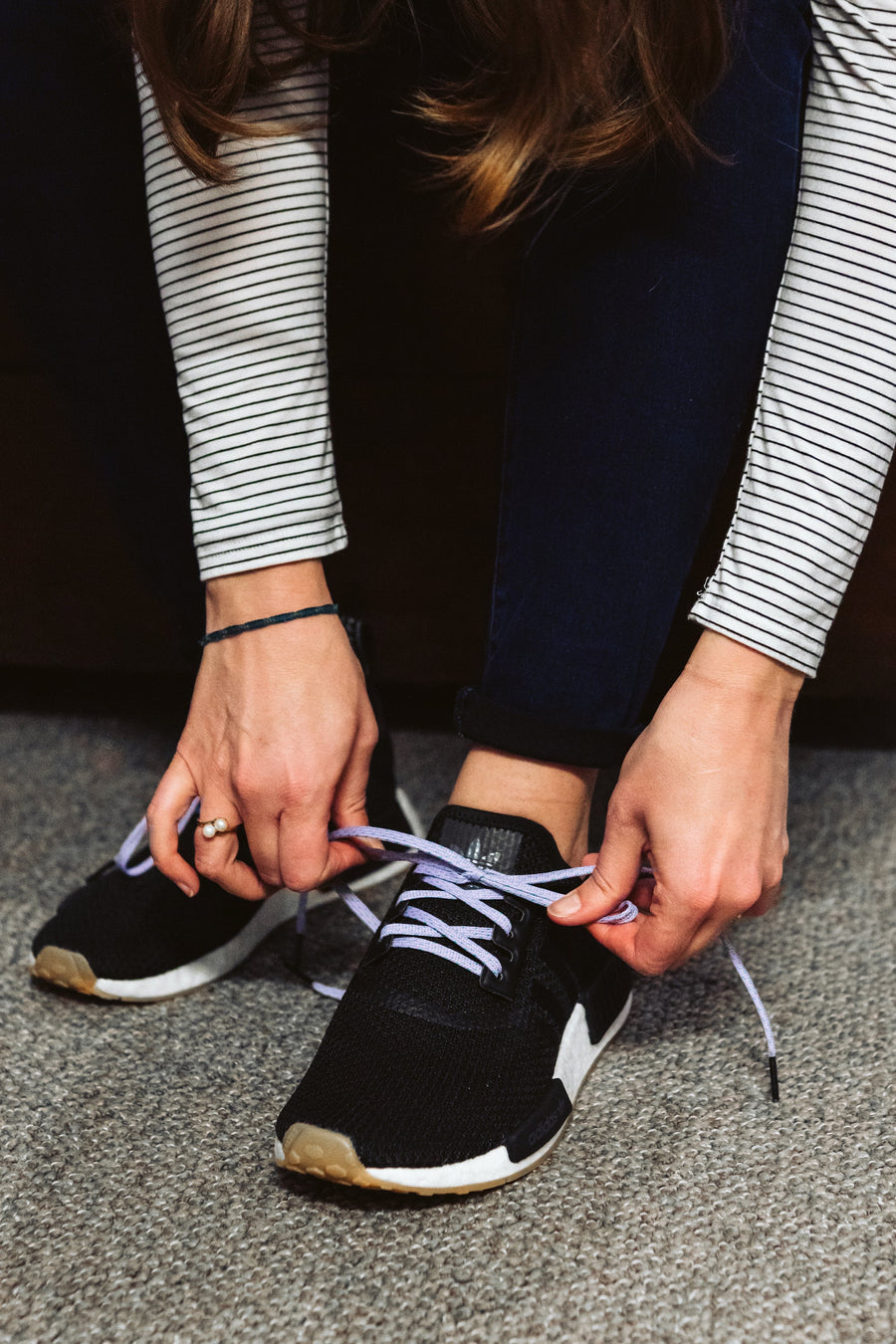 Lavender & Electric Green ticked flat shoelaces being tied on black sneakers