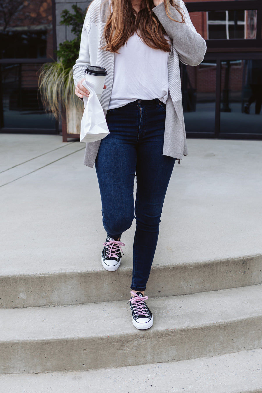 Pink & Light Blue ticked flat shoelaces worn with high-top sneakers on outdoor steps